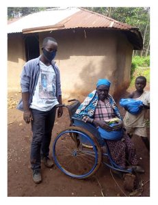 Pastor Kevin distributing Food and soap to an Elderly caregiver